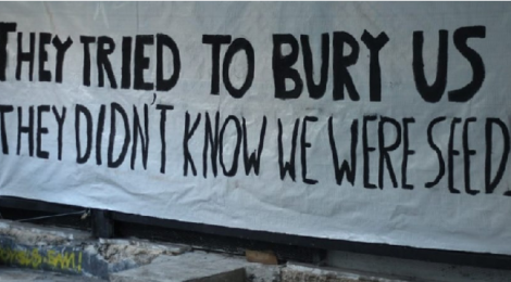 Banner with slogan "The tried to Bury us. They didn't know we were seeds." In solidarity with Exarchia Athens Eviction August 2019